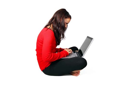 Photograph of woman at laptop working