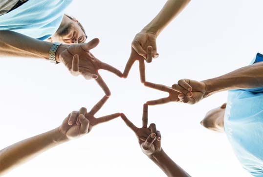 Peoples fingers making a 5 pointed star