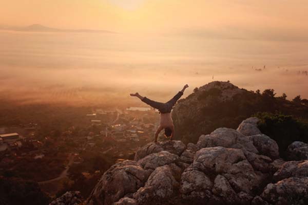 Doing a handstand on a mountain top