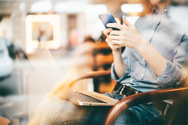 Person using mobile phone in cafe