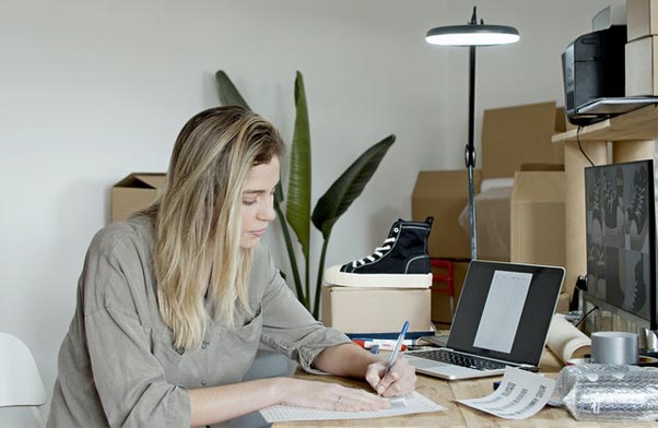 Woman writting at desk