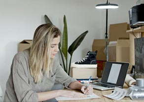 Woman writting at desk
