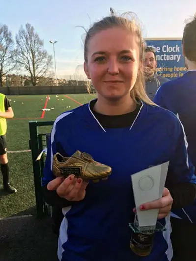 Holding the football trophy